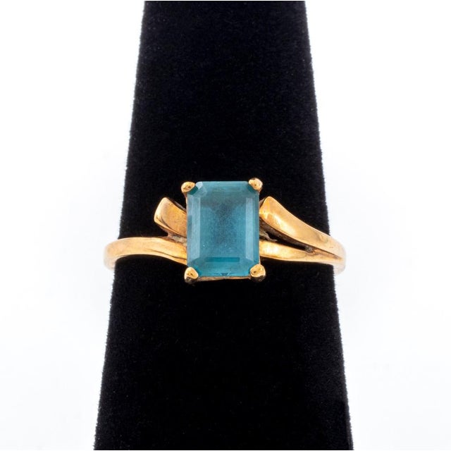 Vintage 10K Yellow Gold Emerald-Cut Blue Topaz Ring, marked "10K. DV. Co". Central topaz approx: 7 x 5 mm. Ring: 0.875" L...