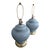 A classic vintage pair of large ginger jar table lamps featuring glossy powder-blue ceramic bodies and polished brass-tone...