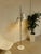 A sleek vintage Mid-Century Modern floor lamp featuring three adjustable cone shades mounted along a slender chrome pole....