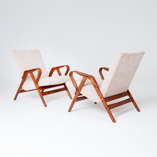 A beautifully refurbished set comprising two iconic armchairs and a matching ottoman, designed by františek jirák for...