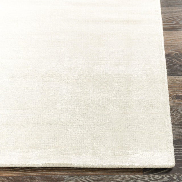 Soft luxurious ivory silk-like viscose-cotton rug. Lightly distressed finish for texture and dimension. Available in...