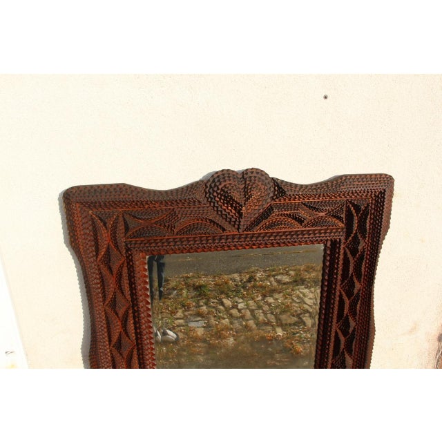 Tramp Art style mirror, typical of 19th-century folk art, probably of French origin. The frame, meticulously hand-carved...