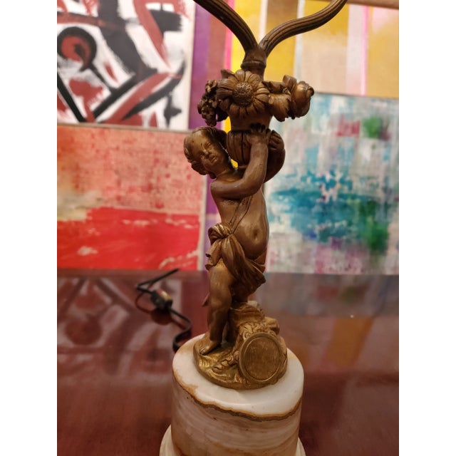 Antique original 19th century French gilt bronze ormolu angel cupid lamp with its original onyx base. Having sharp...