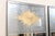 A pair of tall American artisan crafted mirrors with gold verre églomisé sunburst set within upper center within a...