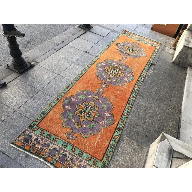 This is a vintage Turkish Oushak rug from the 1960s. The piece was hand-knotted.