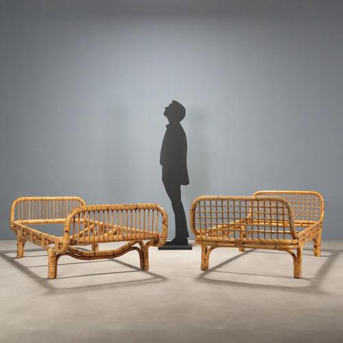 Pair of single bed frames in bamboo and wicker. This piece is attributed to the mentioned designer/maker. It has no...