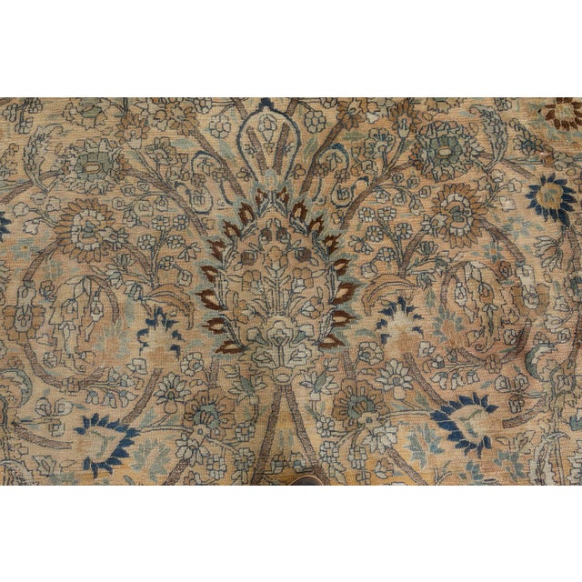 A late 19th century Persian Mashad rug, the camel field with an overall curvilinear trellis of flowering vinery and...