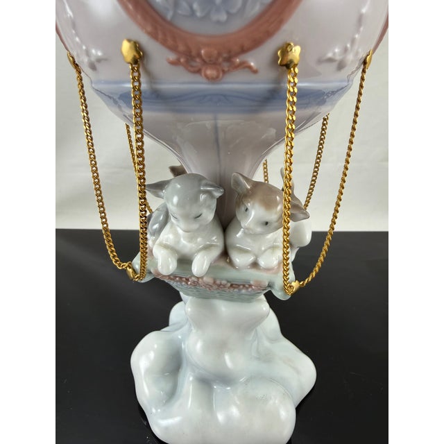 Lladro's "Through The Clouds" 6522 is a glossy figurine issued in 1998 and retired in 2002. It was sculpted by Francisco...