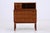 A beautiful teak secretary desk from the 1960s, featuring a clean Danish design and lovely grain. Its writing flap, small...