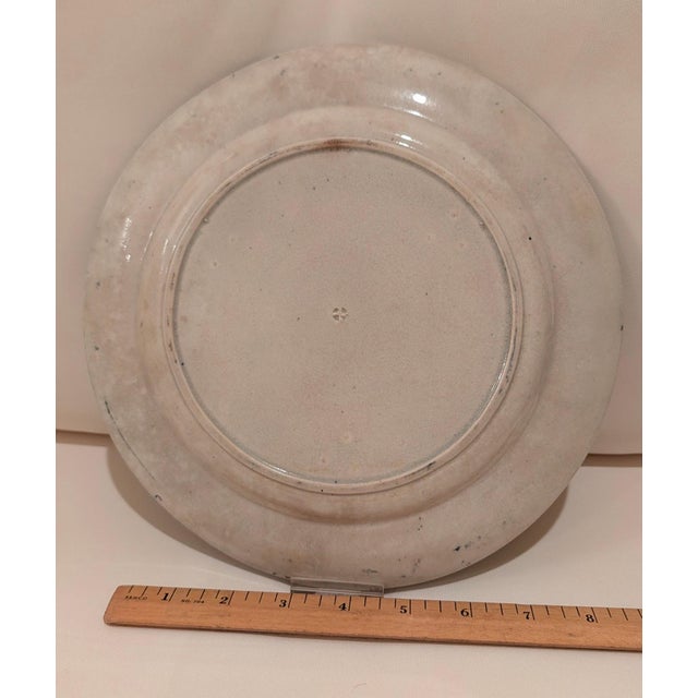 Ceramic plate with no maker's mark on reverse. The Crystal Palace is pictured in blue with a blue floral border.