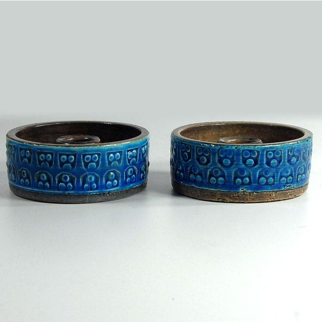 A large table vase made of ceramic decorated with sgraffito and glazed in colors known as Rimini Blue. The vase was...