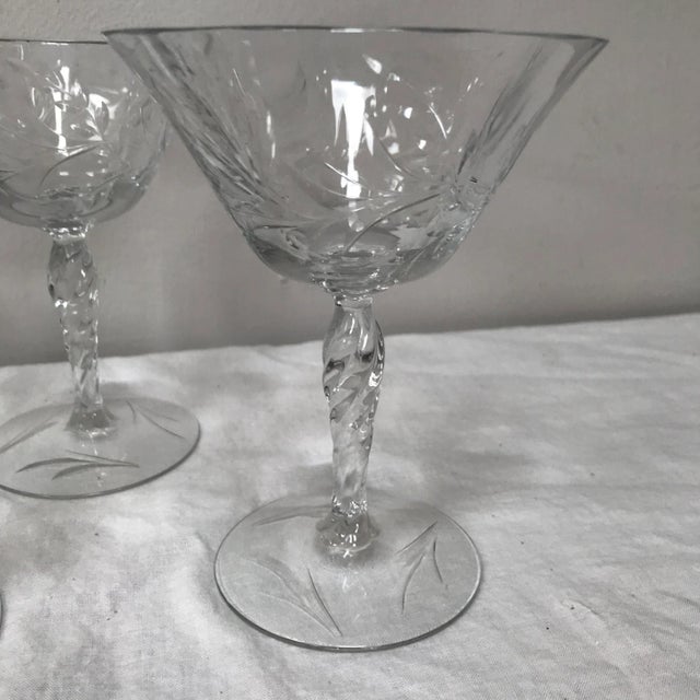 1940’s stemmed wine glasses from an unknown maker. The lightly undulating glass is cut in a stemmed floral and berry...