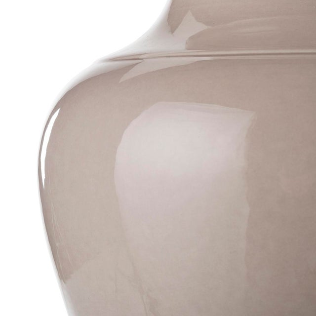 Sinuous and shaped table lamp and shade. this charming table lamp is featured by a curved body. Ceramic is skillfully...