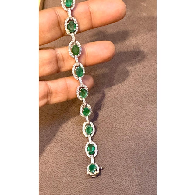 This exceptionally affordable Tennis bracelet has 12 stones of oval Emeralds . Each Emerald is surrounded by brilliant cut...