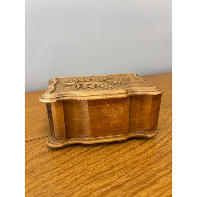 This vintage wooden trinket box is a small, quietly enchanting piece, rich with the intimacy of objects meant to hold what...