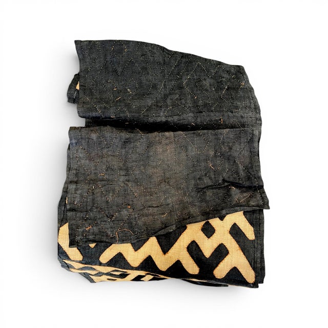 Crafted from authentic Kuba cloth, this long runner showcases the rich texture, intricate geometric patterns, and...