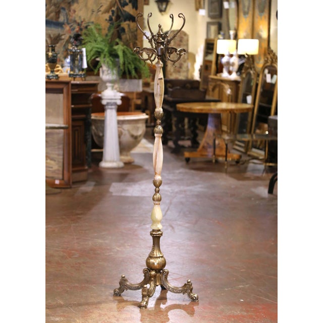 This antique carved onyx and brass hall tree was crafted in France, circa 1920. Standing on an intricate vasiform base...