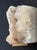 Natural quartz crystal specimen displayed on a custom golden metal stand, transforming a remarkable geological formation...