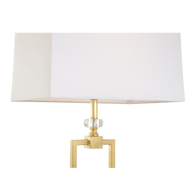 The Serene Table Lamp is a tall, rectangular shape with an open form and acrylic rectangular base. Topped with a white...