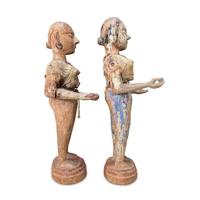 A pair of Indonesian wooden sculptures from the late 1700s depicting two women in carved and lacquered wood with extensive...