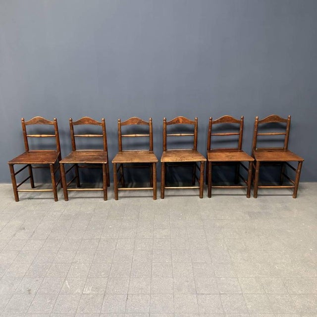 Set of six brown old kitchen chairs from England, around 1900. These chairs are made of oak and pine wood. We cleaned the...