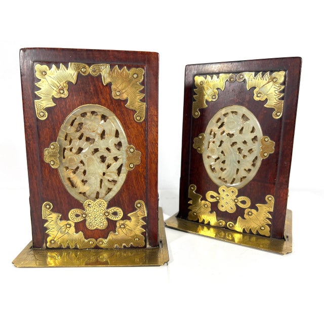 A pair of eye catching Chinese rosewood bookends with a lot of detailing in both the brass and in the carved jade stone...