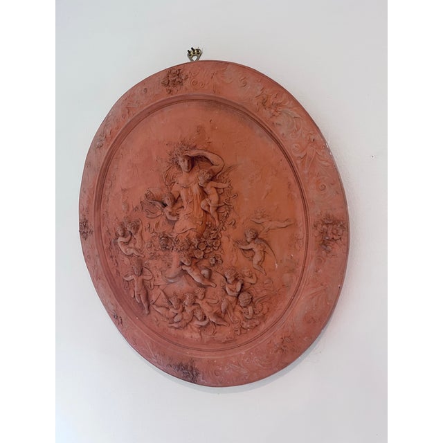A beautifully modeled Italian Neoclassical terracotta relief plaque depicting Flora, the Roman goddess of flowers and...