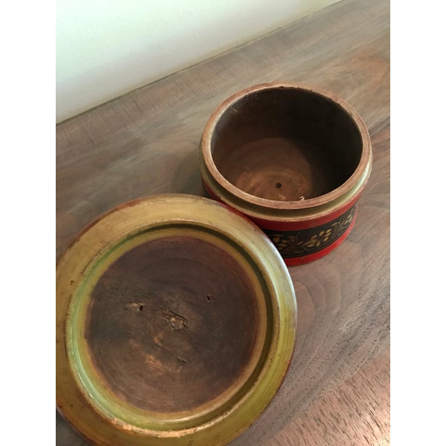 This vintage Punjabi wooden spice box is hand painted in red, black, and saffron yellow. Its primitive floral designs add...