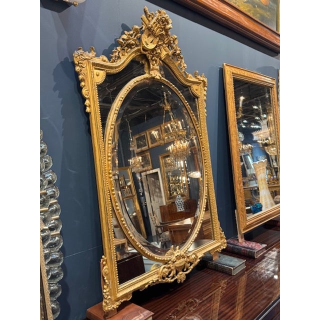 The 19th Century French Carved and Giltwood Mirror exudes a touch of elegance to any home décor. With intricate details...