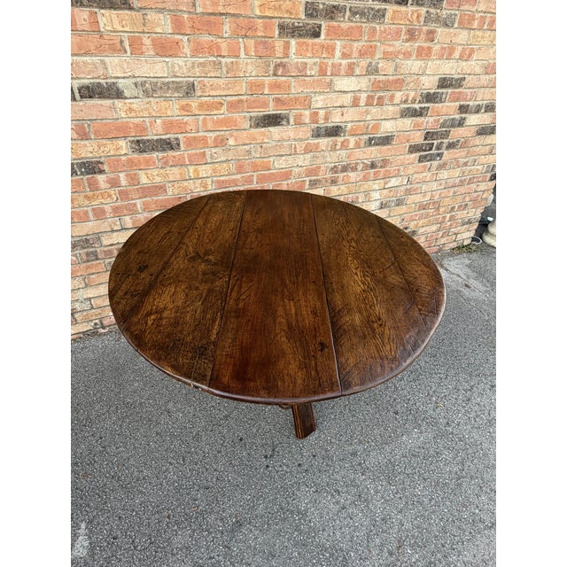 This 19th-century Dutch cricket table exudes timeless elegance, crafted in deep rich oak with lovely three legged trestle...