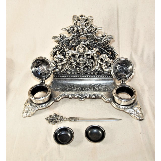 A vintage Italian silver plate over brass inkwell. Inkwell has 2 wells with inserts and matching letter opener. Theme of...