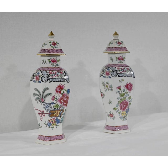 Pair of hexagonal vases in fine earthenware with polychrome decorations of flowers, vases and fans in pastel tones. The...
