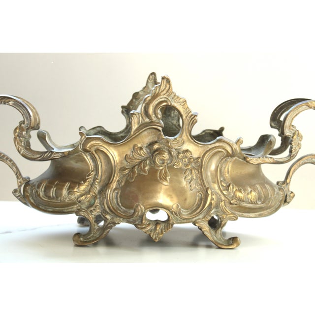Exceptionally elegant, unlacquered jardinière that was created in Paris, France, circa 1850. The antique planter sits on...