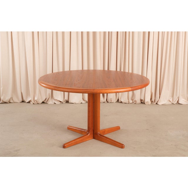 A 1960s extendable round teak dining table by Laurits M. Larsen for Møbelfabrik A/S, one of the more versatile and...