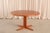 A 1960s extendable round teak dining table by Laurits M. Larsen for Møbelfabrik A/S, one of the more versatile and...
