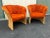 Mid century modern rattan tub chairs with original vintage orange chenille upholstery. These chairs feature a channel back...