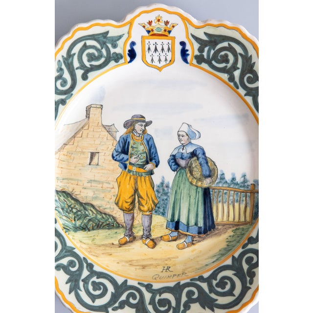 A charming antique French faience Quimper hand painted couple plate, circa 1895. Maker's mark on front. This lovely large...