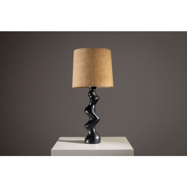 This wooden Temde Typ 42 table lamp is a beautiful example of mid-century German-Swiss design, where sculptural form meets...