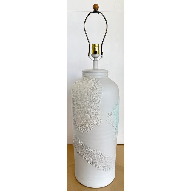 Vintage plaster table lamp featuring a textured design. Plaster base with a cold white finish and light pink, light yellow...