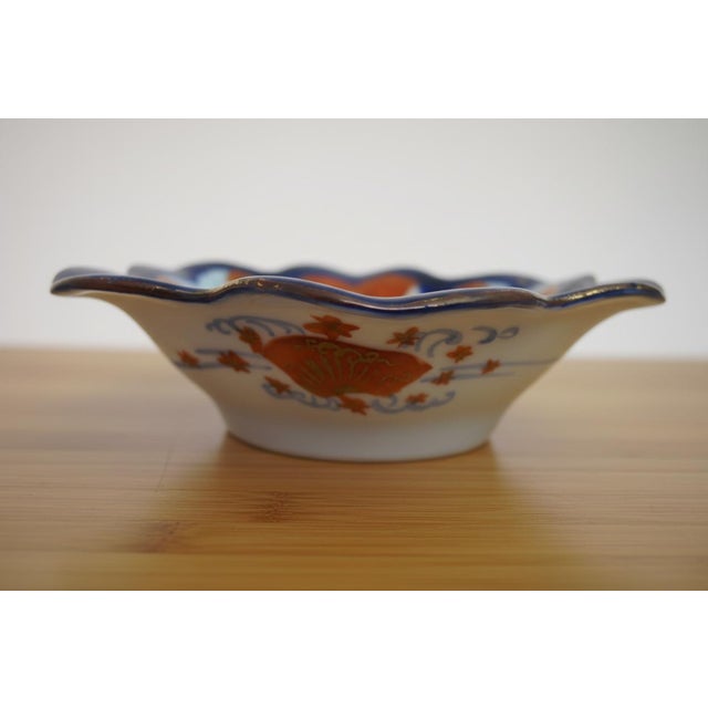 Set of porcelain Japanese Kutani dishes. Shell shaped with figural focal point, cobalt blue and red with gold accents....