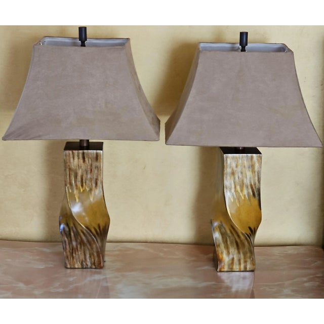 A gorgeous pair of large, wood look twisted stem resin table lamps with matching finials and suede lampshades. Features:...