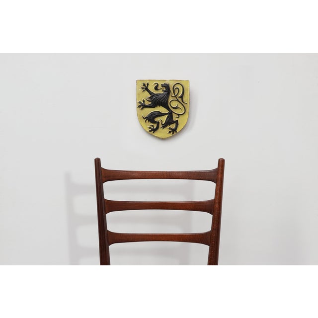 This heraldic ceramic wall plaque features the black Flemish lion (Leeuw van Vlaanderen) in relief against a yellow glazed...