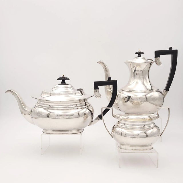 A three-piece silver plate tea or coffee set, England circa 1950, made by Sheffield. The larger pot measures 8.75" h x...