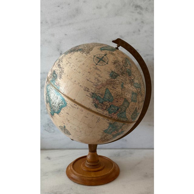 Vintage 12" Replogle World Classic Series globe featuring an antiques style map, bronzed metal meridian and a turned wood...