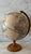Vintage 12" Replogle World Classic Series globe featuring an antiques style map, bronzed metal meridian and a turned wood...