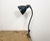 Industrial adjustable table lamp made by Siemens in Germany during the 1950s.It features grey enamel shade with white...