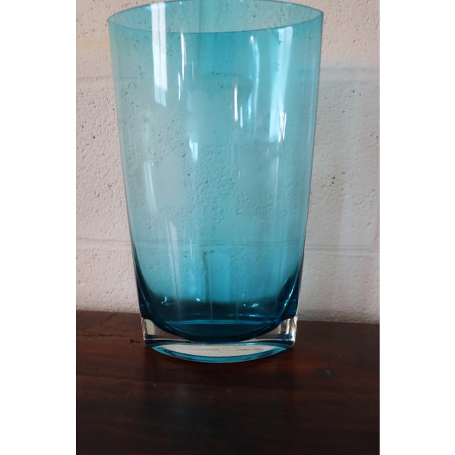 Blue art glass vase with etched floral design.