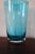 Blue art glass vase with etched floral design.