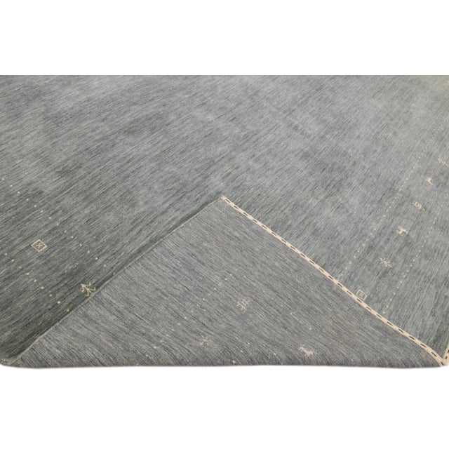 Beautiful modern Gabbeh style hand-Loom wool rug with a gray field. This Gabbeh-style rug has white accents in a gorgeous...