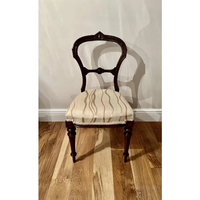 Set of four antique Victorian quality carved walnut dining chairs having a quality carved solid walnut shaped back with a...